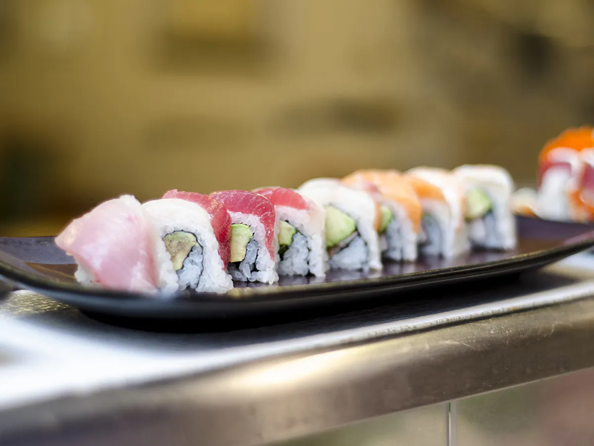 Fresh tuna salmon avocado sushi rolls on dark plate at Kanji Asian Bistro & Sushi Bar，an Asian Fusion Restaurant in Newark